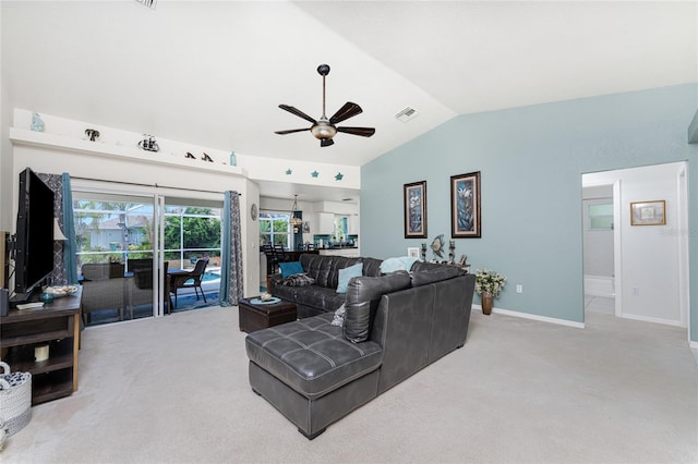 living room featuring ceiling fan, carpet floors, and lofted ceiling