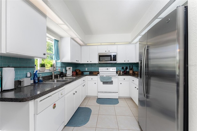 kitchen with sink, backsplash, white cabinetry, and appliances with stainless steel finishes