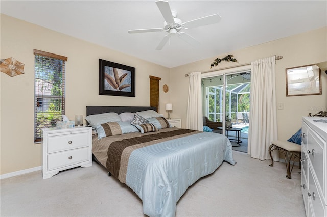 carpeted bedroom featuring ceiling fan, access to exterior, and multiple windows