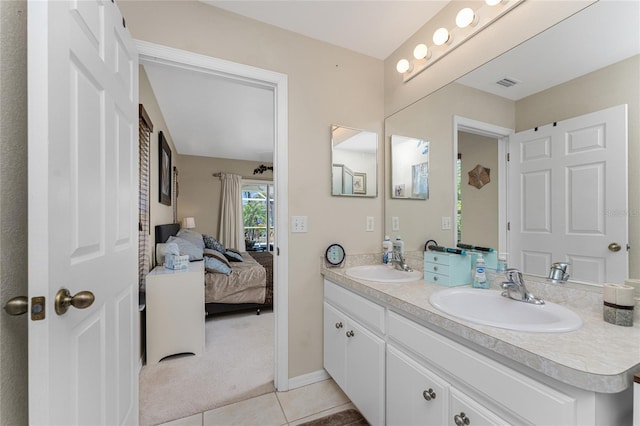 bathroom featuring oversized vanity, double sink, and tile floors