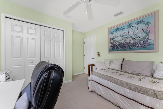 bedroom with ceiling fan, a closet, and carpet flooring