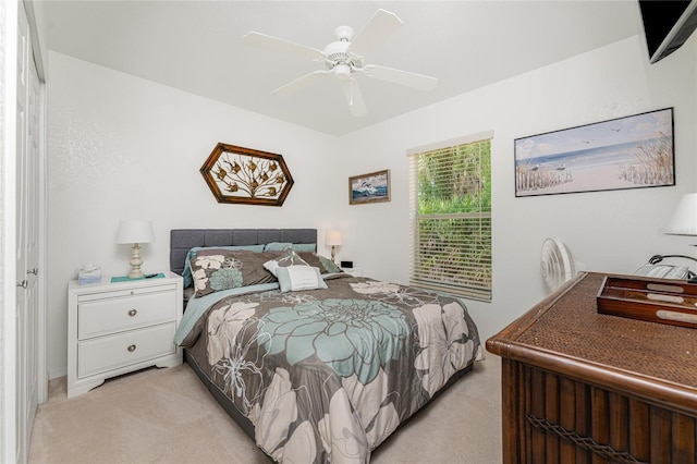 bedroom featuring ceiling fan and light colored carpet