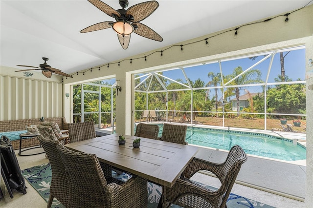 sunroom with ceiling fan and lofted ceiling