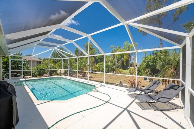 view of swimming pool with a lanai and a patio area