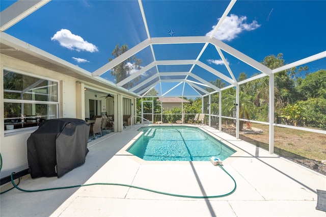 view of pool with a patio area, ceiling fan, and grilling area