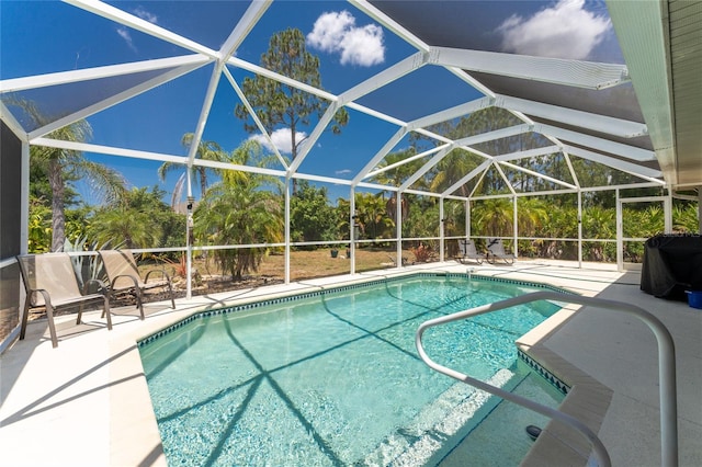 view of swimming pool featuring a lanai and a patio