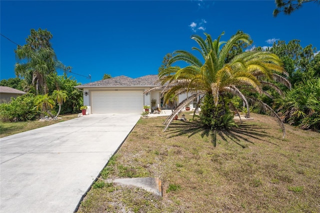 view of front of home featuring a garage and a front lawn