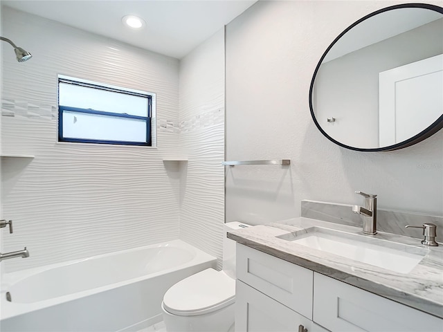 full bathroom with toilet, vanity, and tiled shower / bath