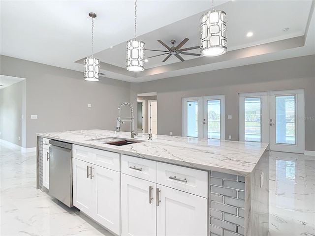 kitchen featuring dishwasher, a kitchen island with sink, french doors, ceiling fan, and white cabinetry