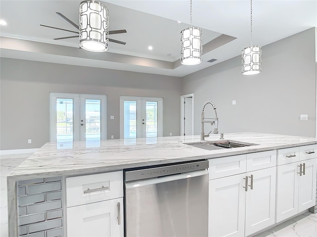 kitchen featuring french doors, white cabinets, a raised ceiling, sink, and stainless steel dishwasher