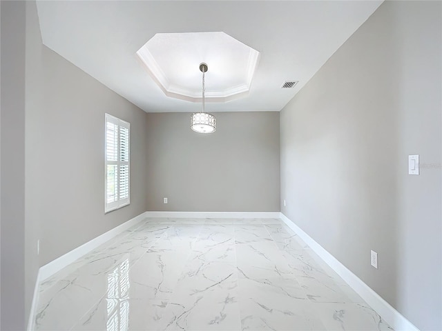 unfurnished room with a tray ceiling