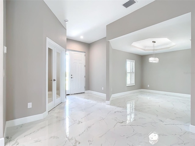 entrance foyer featuring a raised ceiling