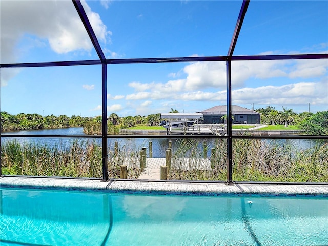 view of pool with a boat dock, a water view, and a lanai