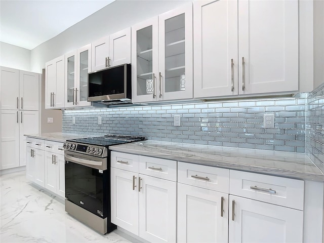 kitchen with backsplash, light stone countertops, white cabinets, and stainless steel appliances