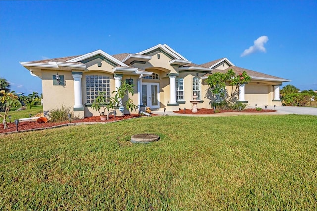 view of front of house with a garage, a front yard, and french doors