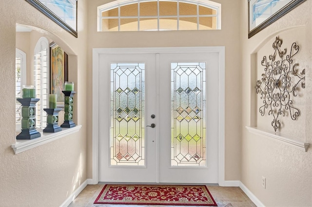 entryway featuring a wealth of natural light and french doors