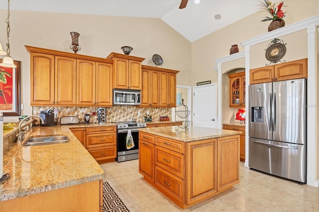 kitchen featuring sink, a center island, hanging light fixtures, tasteful backsplash, and appliances with stainless steel finishes