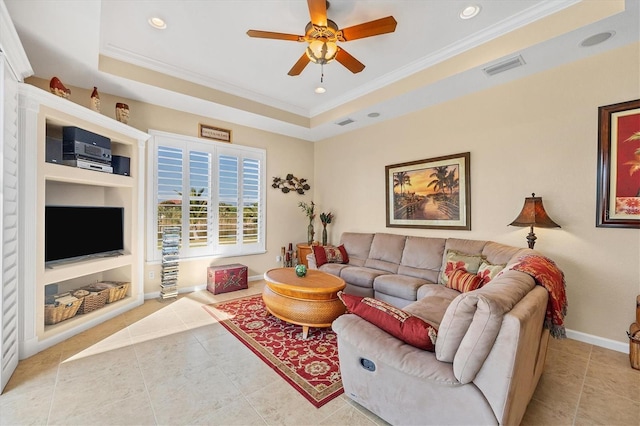 living room featuring ceiling fan, built in features, a tray ceiling, light tile patterned floors, and ornamental molding