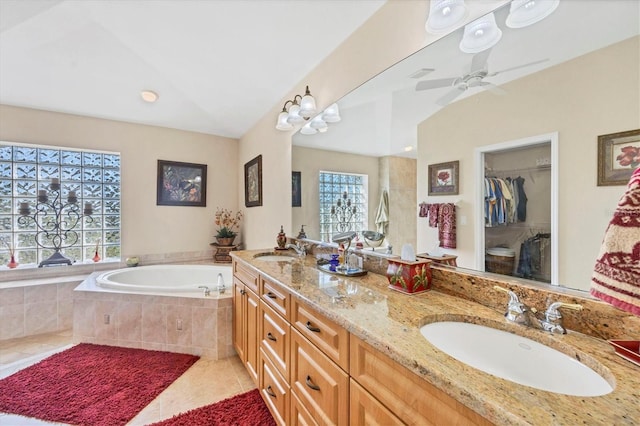 bathroom featuring vanity, tile patterned floors, vaulted ceiling, ceiling fan, and tiled bath