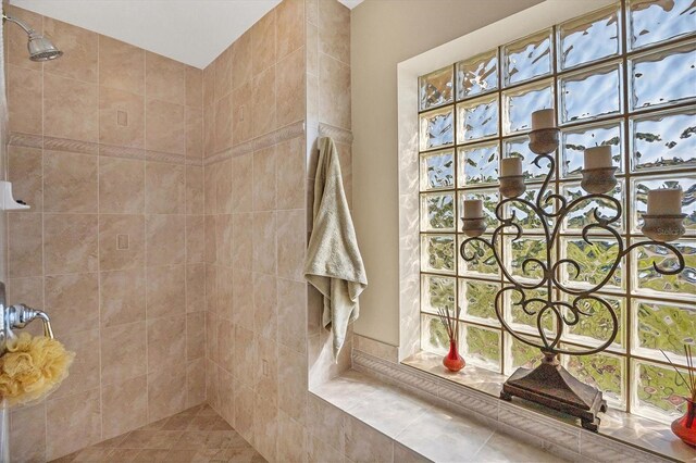 bathroom with a tile shower