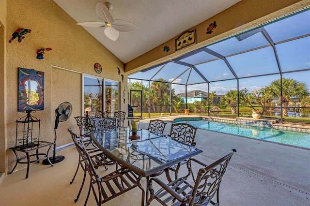 view of pool with glass enclosure, ceiling fan, and a patio area