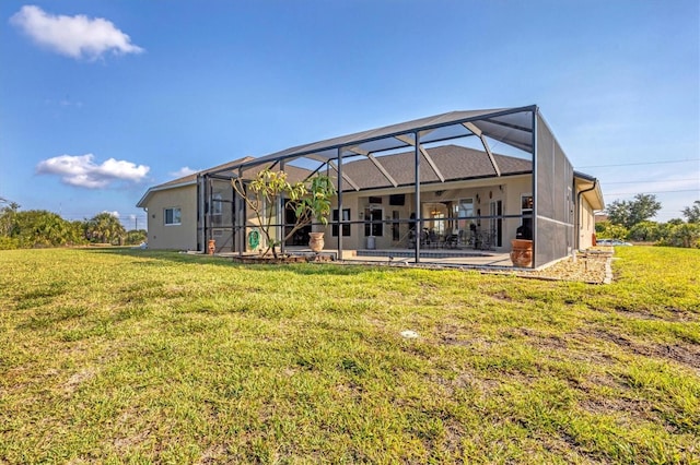 rear view of house featuring a patio, a yard, and glass enclosure