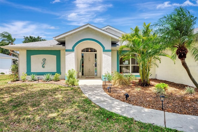 ranch-style home featuring a front yard