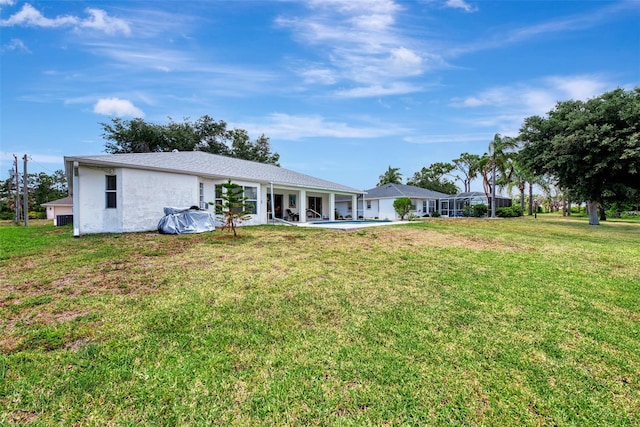 rear view of property with a yard