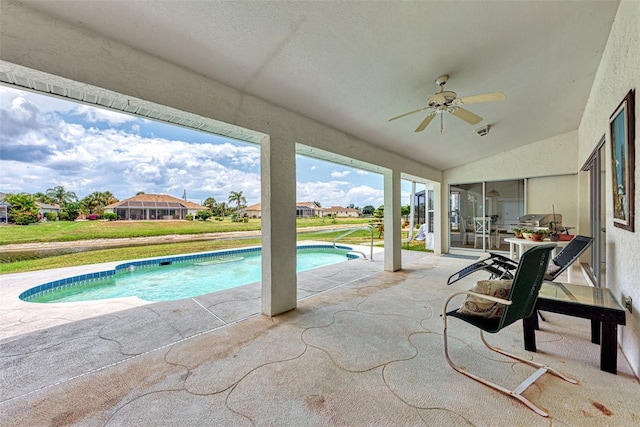 view of swimming pool featuring ceiling fan and a patio