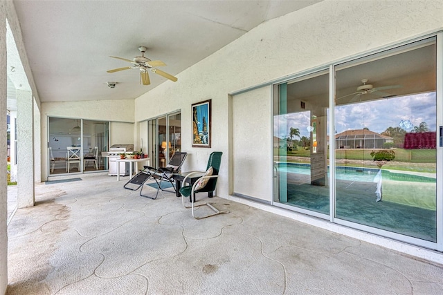 sunroom with ceiling fan and vaulted ceiling