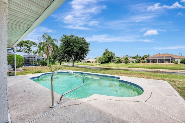 view of pool with a yard