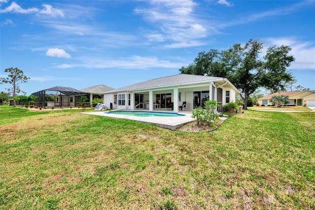 rear view of house with a patio and a lawn