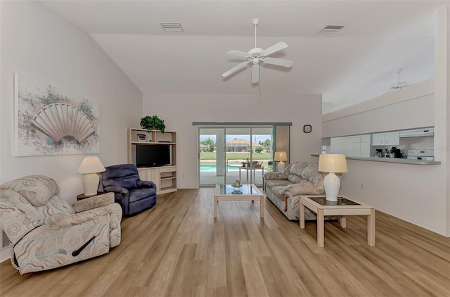 living room with vaulted ceiling, ceiling fan, and light wood-type flooring