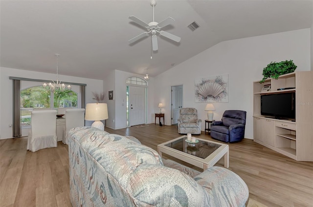 living room with light wood-type flooring, vaulted ceiling, and ceiling fan with notable chandelier