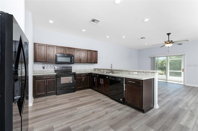 kitchen featuring light hardwood / wood-style flooring, sink, dark brown cabinets, and black appliances