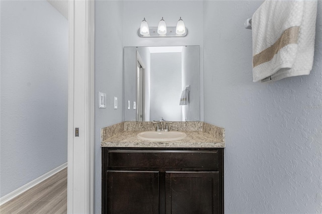 bathroom featuring vanity and hardwood / wood-style floors