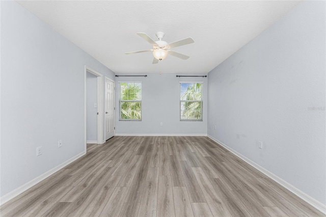 unfurnished room with ceiling fan and light wood-type flooring