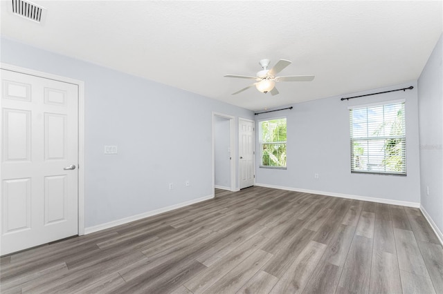 spare room featuring ceiling fan and light hardwood / wood-style floors