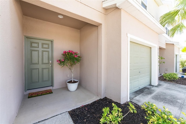 view of exterior entry with a garage