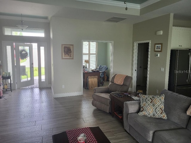 living room with wood-type flooring and crown molding