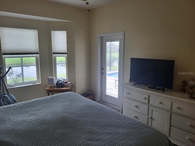 bedroom featuring multiple windows and access to exterior