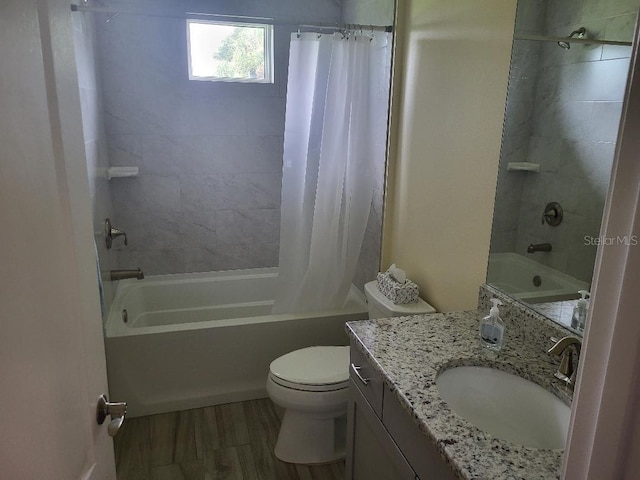 full bathroom featuring hardwood / wood-style flooring, toilet, shower / bathtub combination with curtain, and vanity