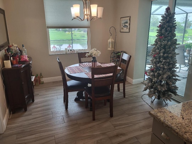 dining area featuring hardwood / wood-style floors and an inviting chandelier