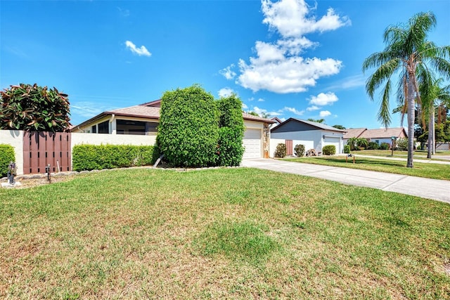 view of front of house with a garage and a front yard