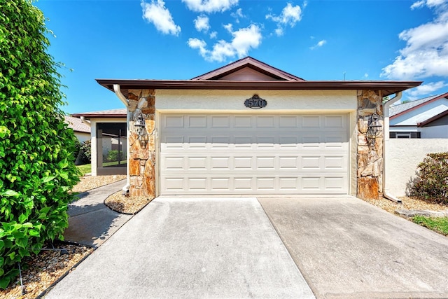 view of front of property featuring a sunroom and a garage