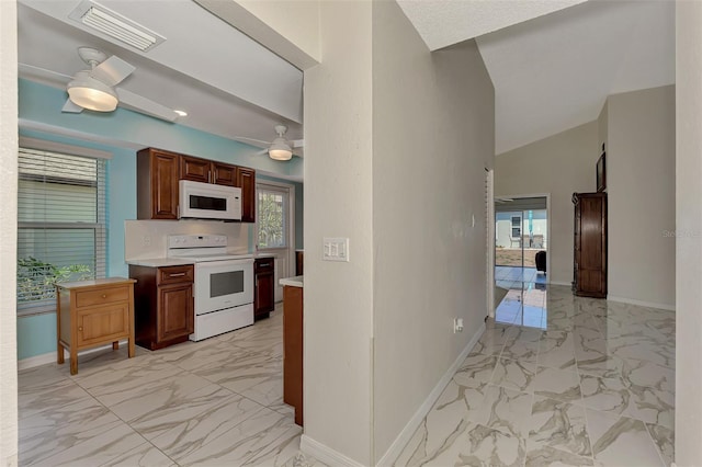 kitchen featuring lofted ceiling, ceiling fan, and white appliances