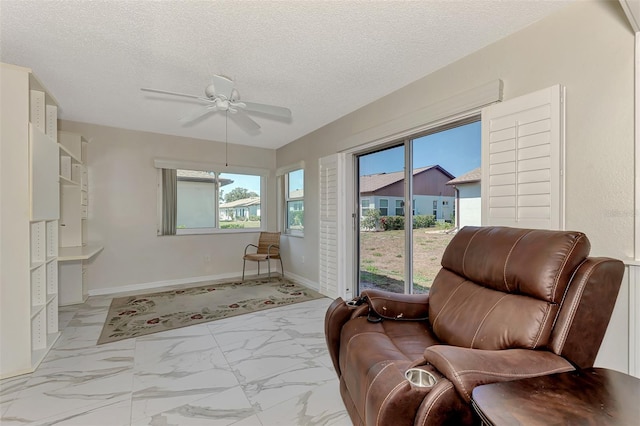 sitting room featuring a textured ceiling and ceiling fan