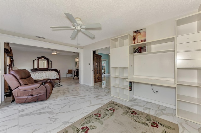 interior space featuring a textured ceiling and ceiling fan