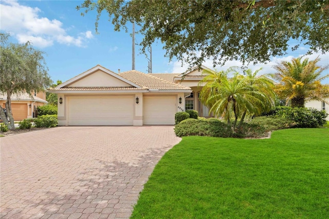 view of front facade featuring a front yard and a garage