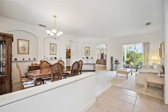 dining room featuring light tile patterned flooring and a chandelier